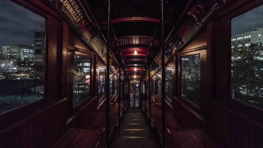 Inside a trolley navigating city streets at night