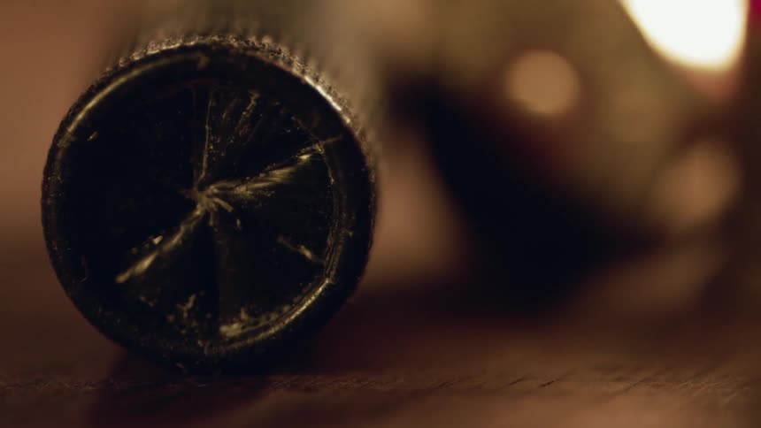 A cracked bullet sits on the table