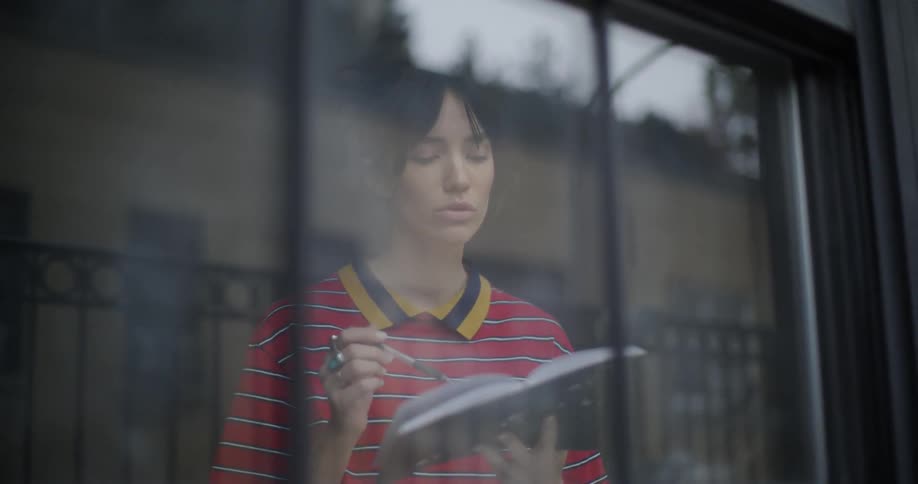 Woman writes in a notebook while singing