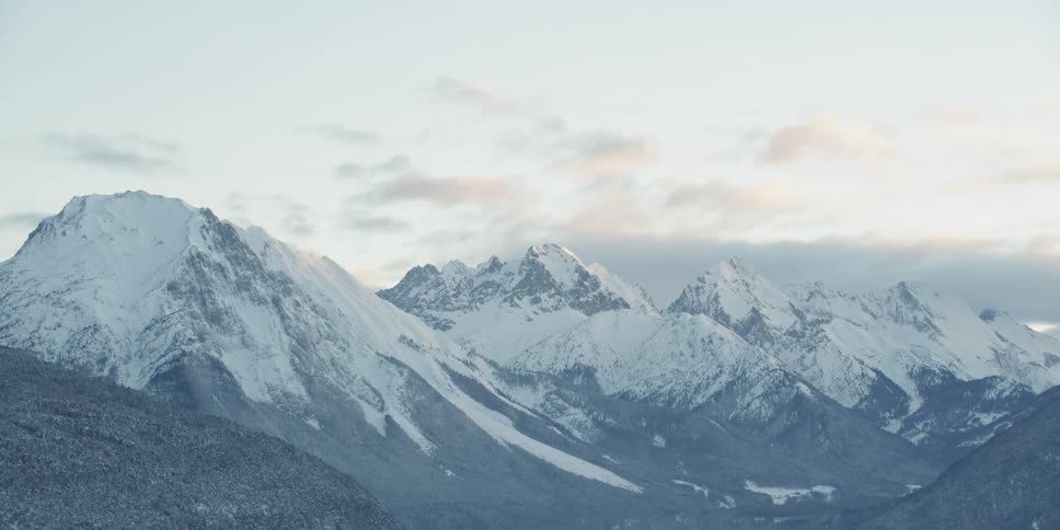 Now covered mountains sit under a blue sky