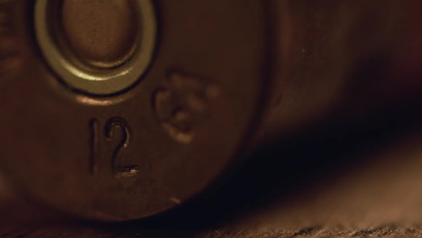 The bullet on the table has numbers etched in it