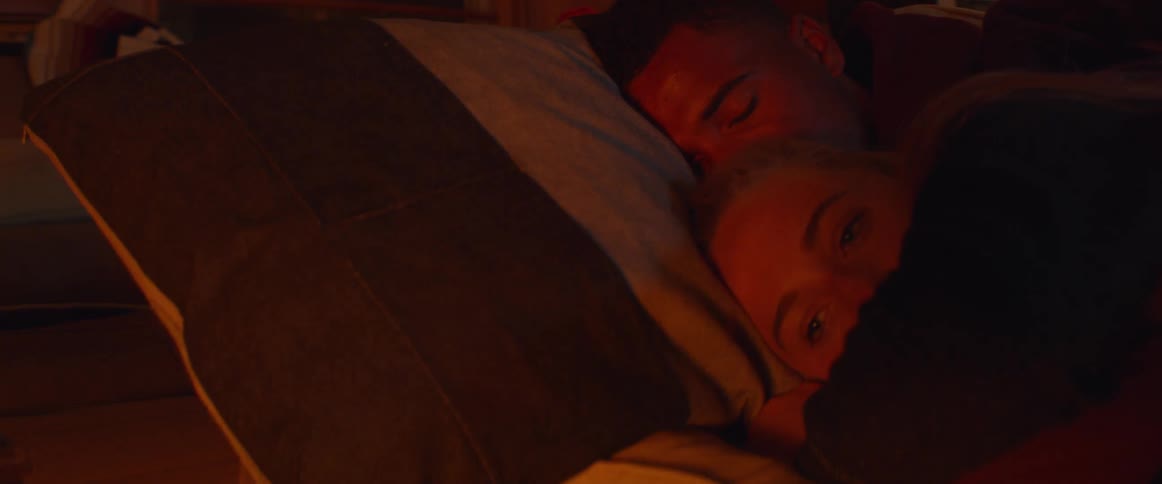 A woman lays awake in a man's arms
