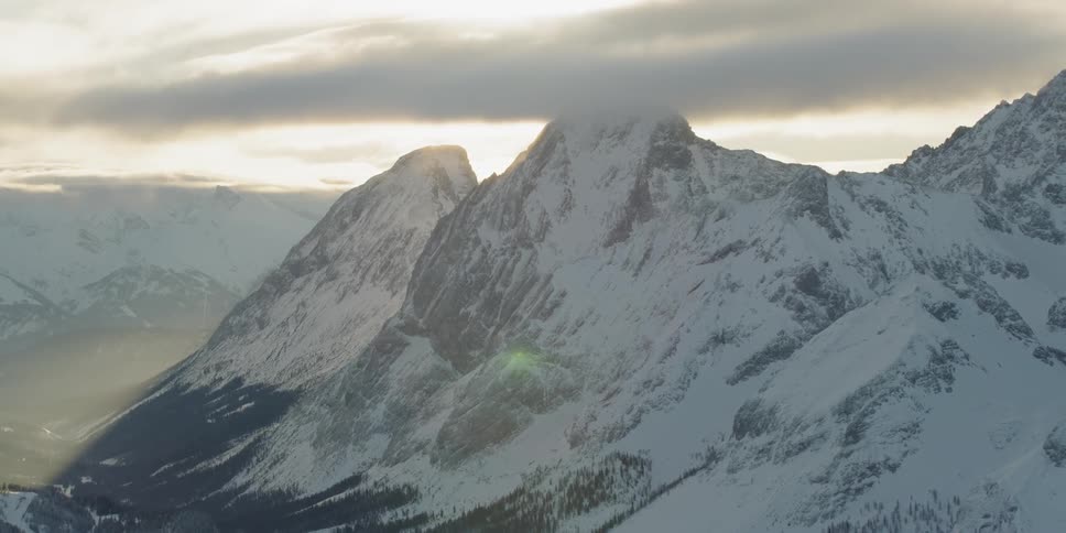 The sunset over snow covered mountain ridges
