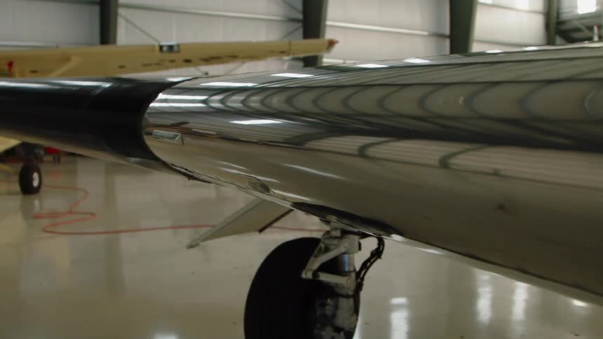 The long wing on the plane is made of reflective metal