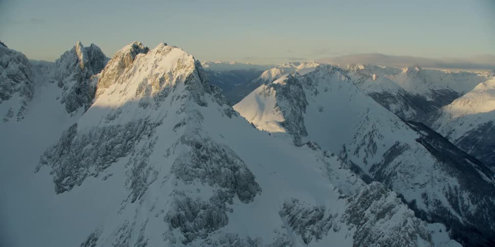 The mountain is white and covered in shadows