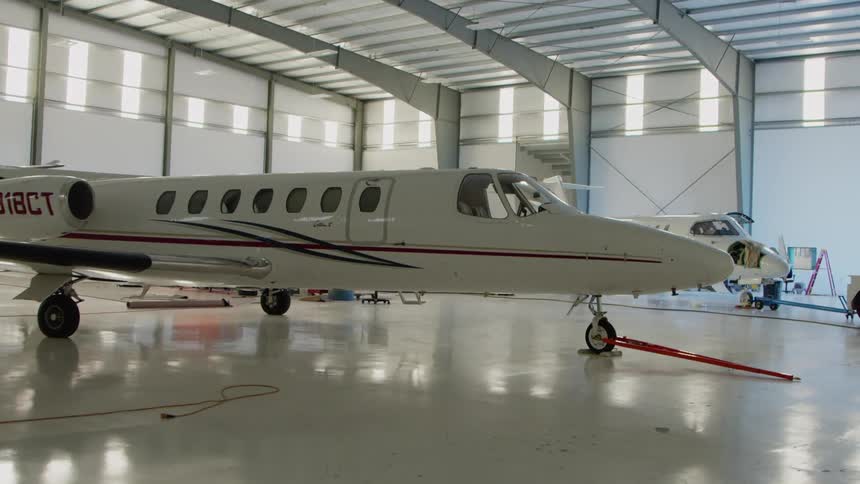White airplane in a large airplane garage