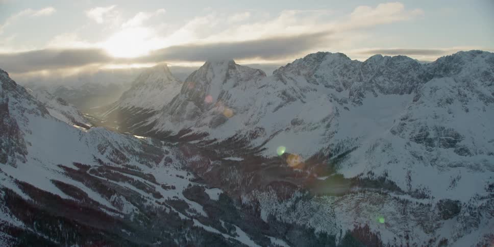 Snow covered mountain range on cloudy day