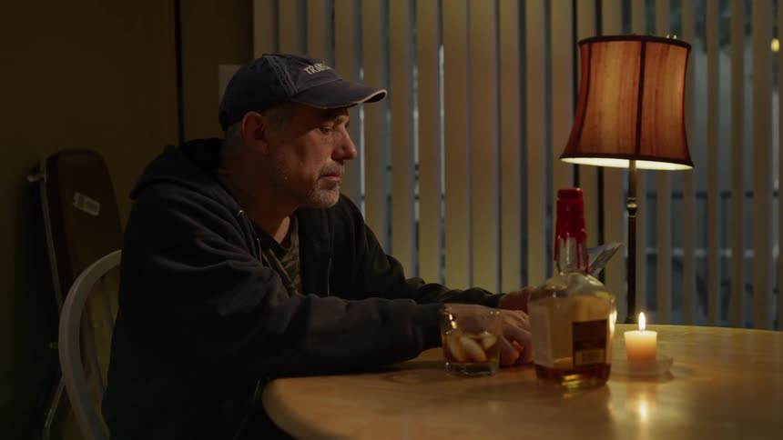 Man sitting at a table drinking alcohol