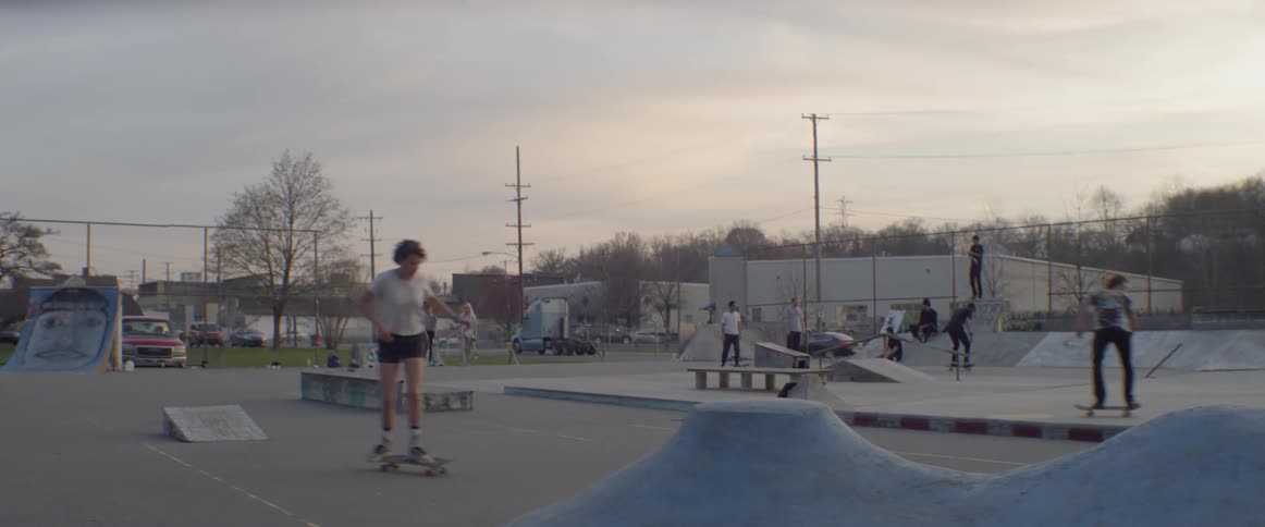 Skateboarders ride in an outdoor skate park