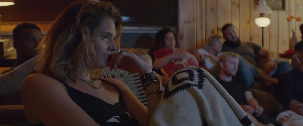 People sit in the living room watching the television