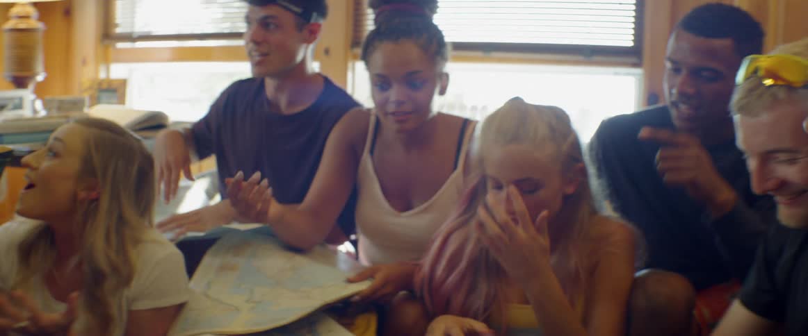 The people sit around looking at a map
