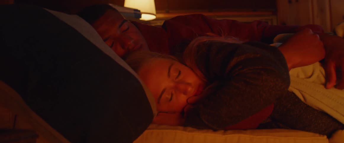 A couple rest in bed together