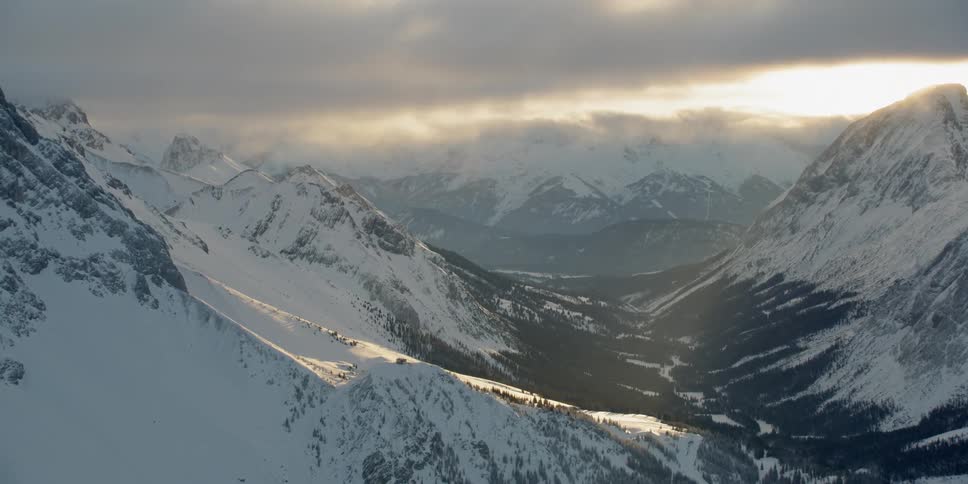 Sun shines down over snowy mountains