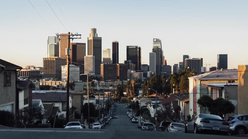 Down the hill is a city with tall buildings