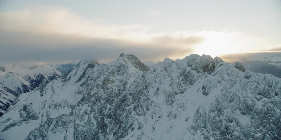 Snow covered mountain peaks at sunset