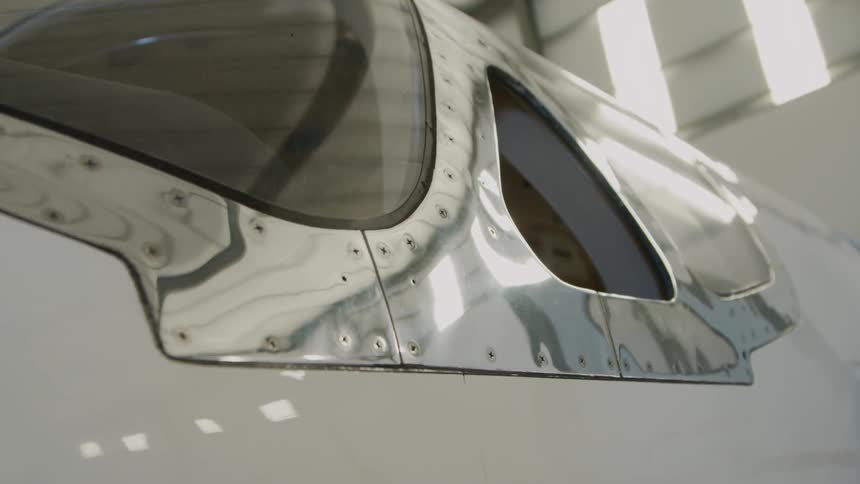 Plane sitting in a hangar in the daytime
