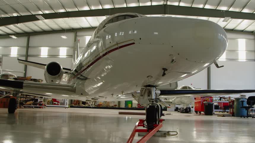 An airplane sits parked in a hangar