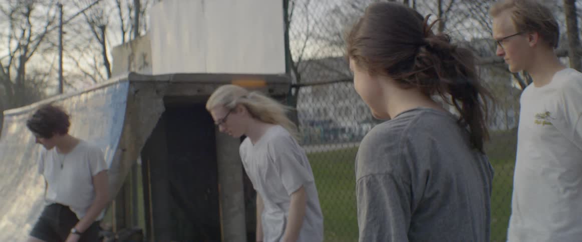 Girls are skating in a park together
