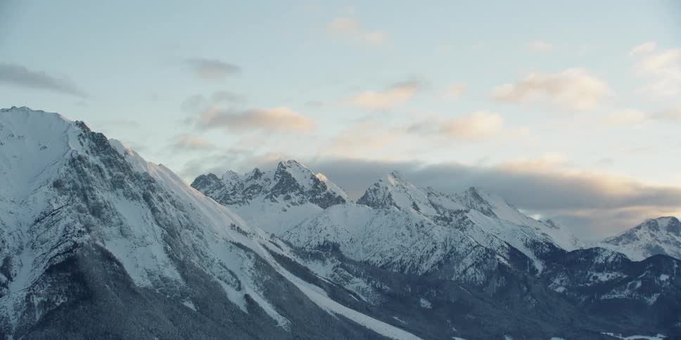 Small clouds float over the mountain range