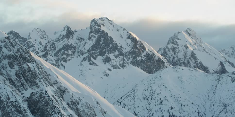 Sun shines down over snowy mountains