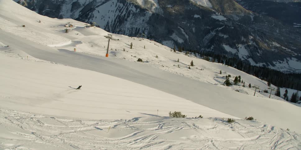 Person snowboarding down a large mountain
