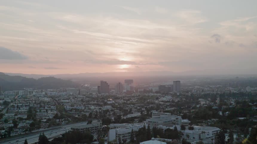 The sun sets over a city