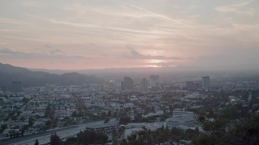 The sun sets over a city