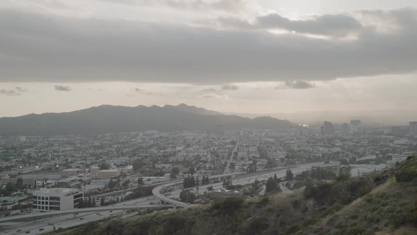 Clouds float above a city at sunset