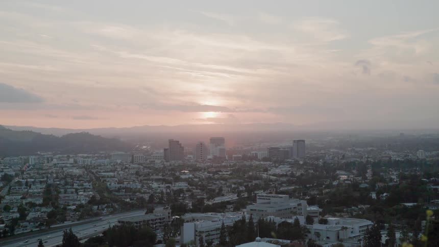 The sun sets over a city