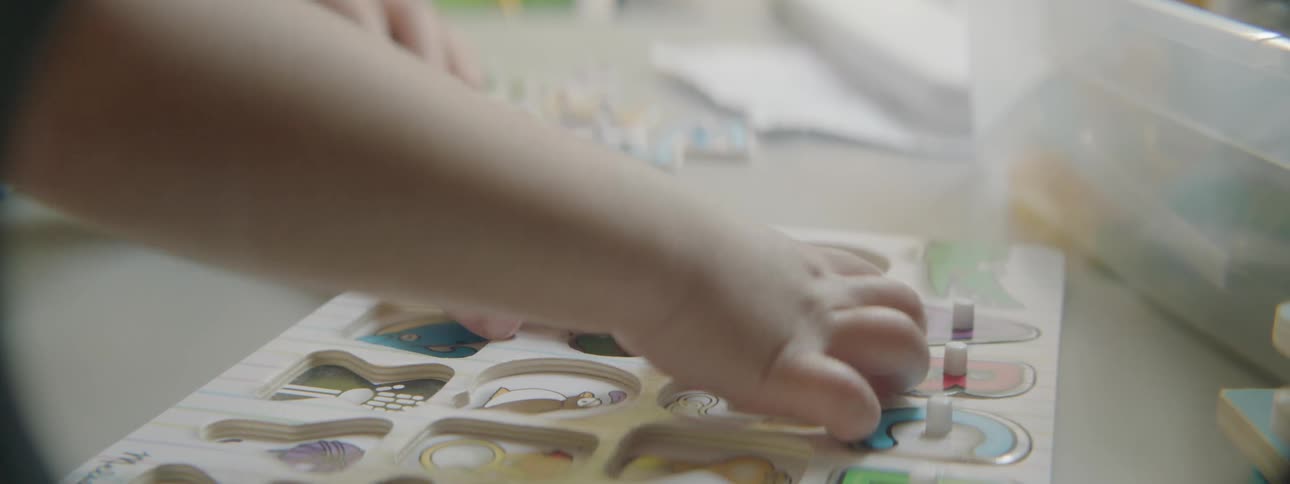 A child plays with wood toys