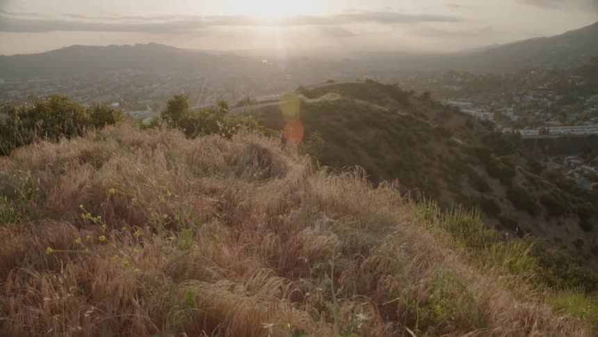 Grass and shrubs cover the hilly landscape