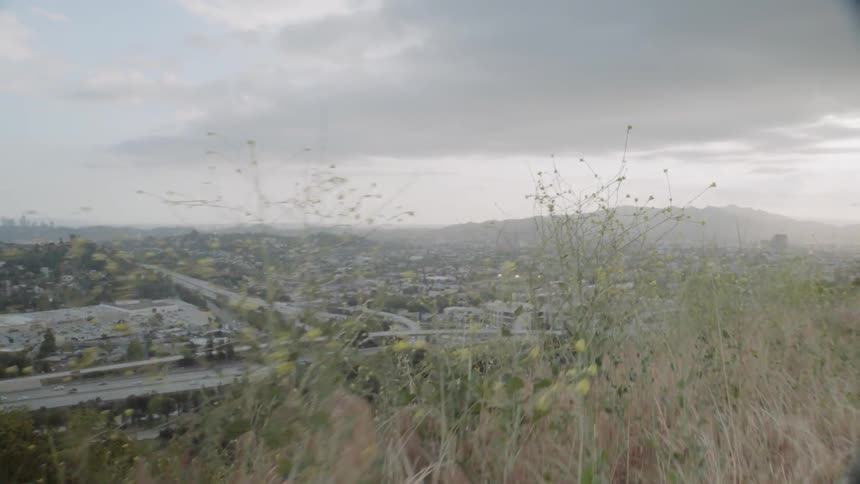 The trail runs on the hill above the city below