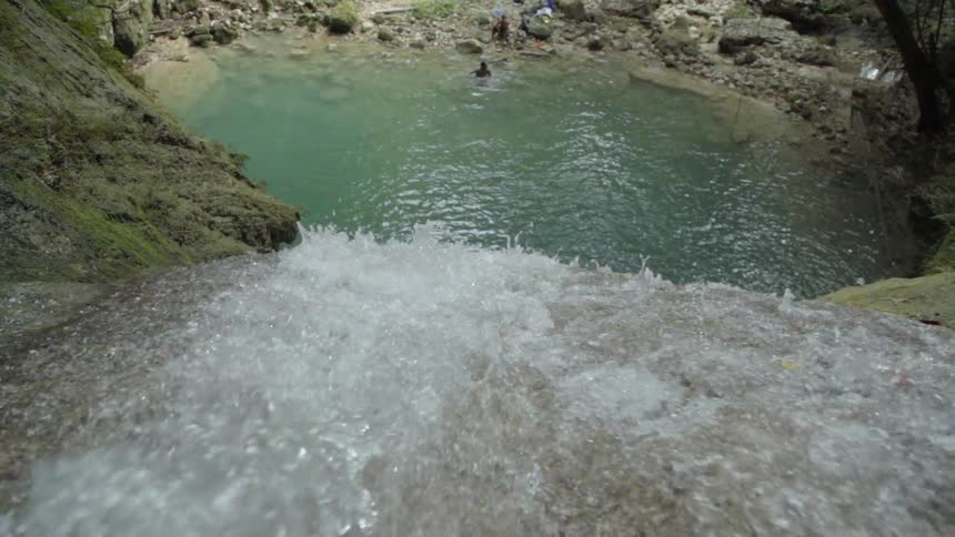 A waterfall crashes down some rocks