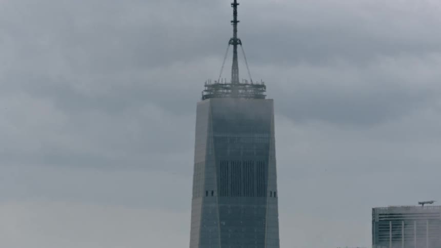 Clouds float above skyscrapers in a city