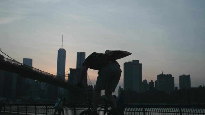 Man does stunts on a bicycle under a blue sky