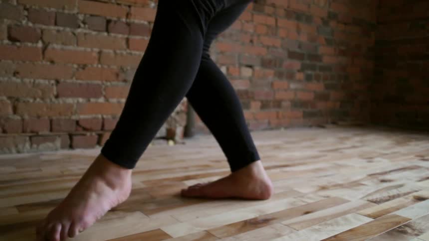 Person dancing on a wooden floor
