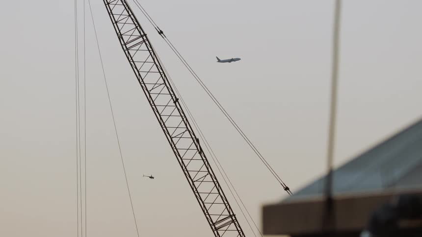 The plan flies high above the helicopter