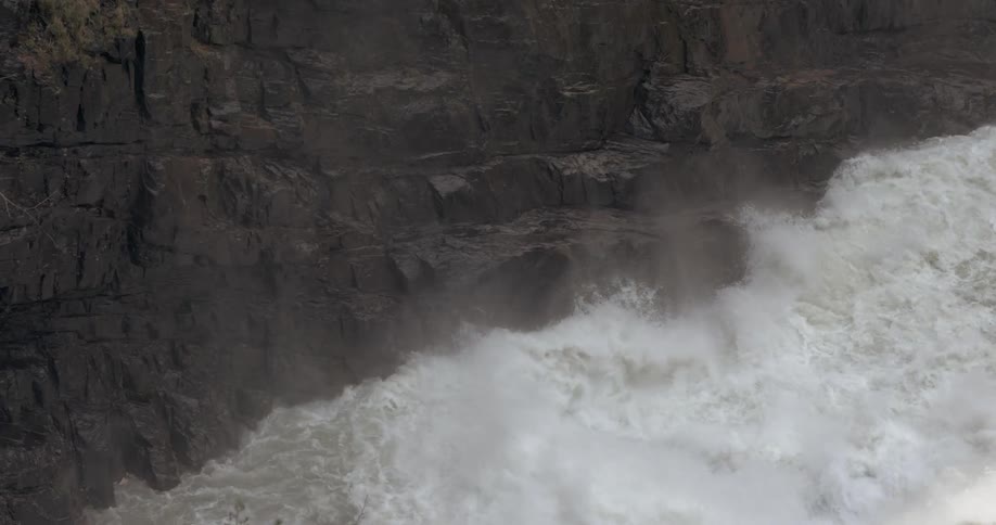 Rapids are crashing through a narrow gorge during the day