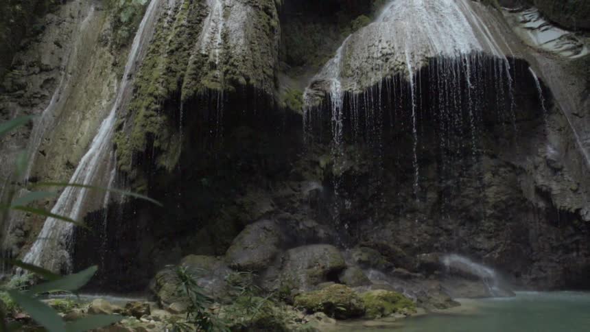 Large cliff with water pouring down below