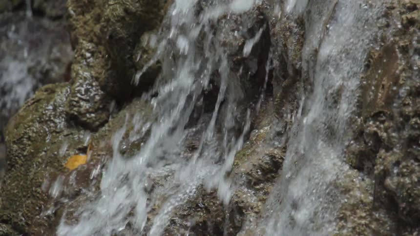 Water splashes over a rock