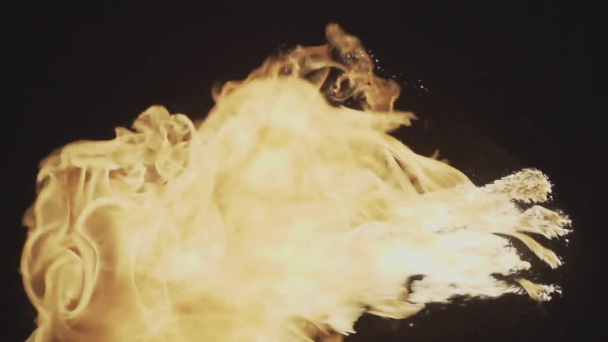 Flame being blown against black backdrop