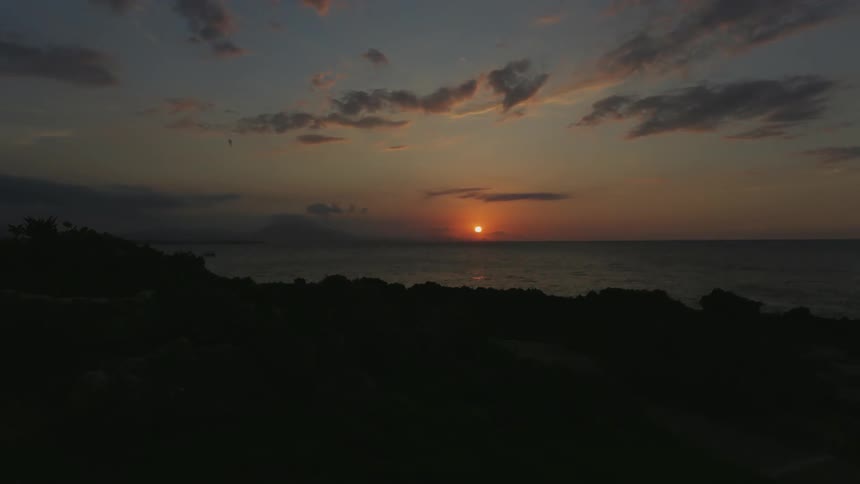 The sun sets over the ocean