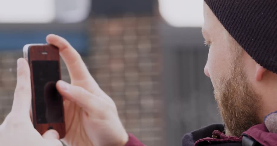 Man standing outside using a cell phone
