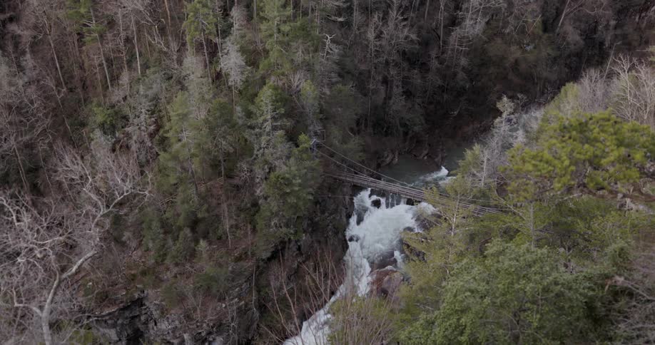 The rope bridge gaps the rough stream below