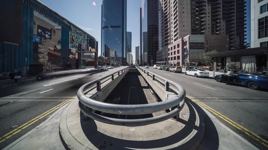 Many vehicles drive down a busy city street