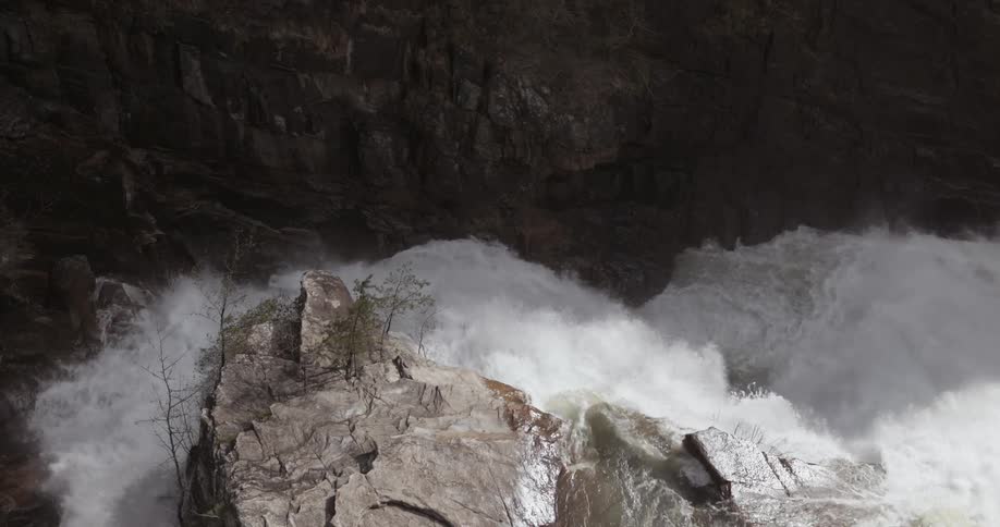 Rapids are crashing through a narrow gorge during the day