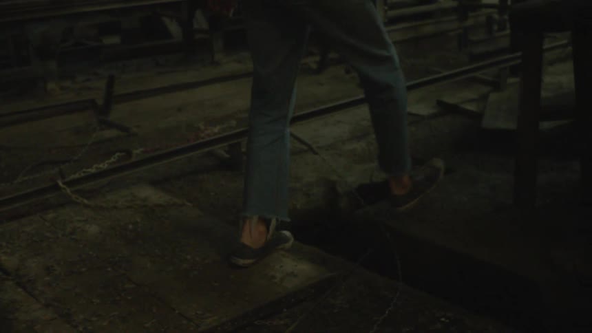 Man walks in a dirty warehouse