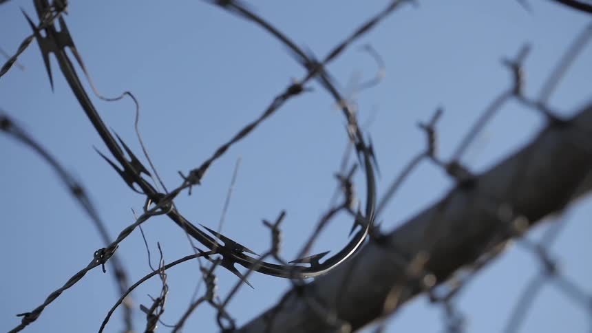 The barbed wire sits on the top of the fence