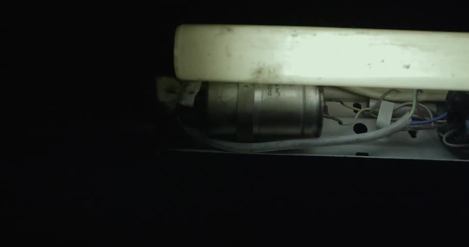 Pipes and flickering lights in a dark room