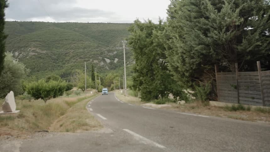 A car is driven on a rural road